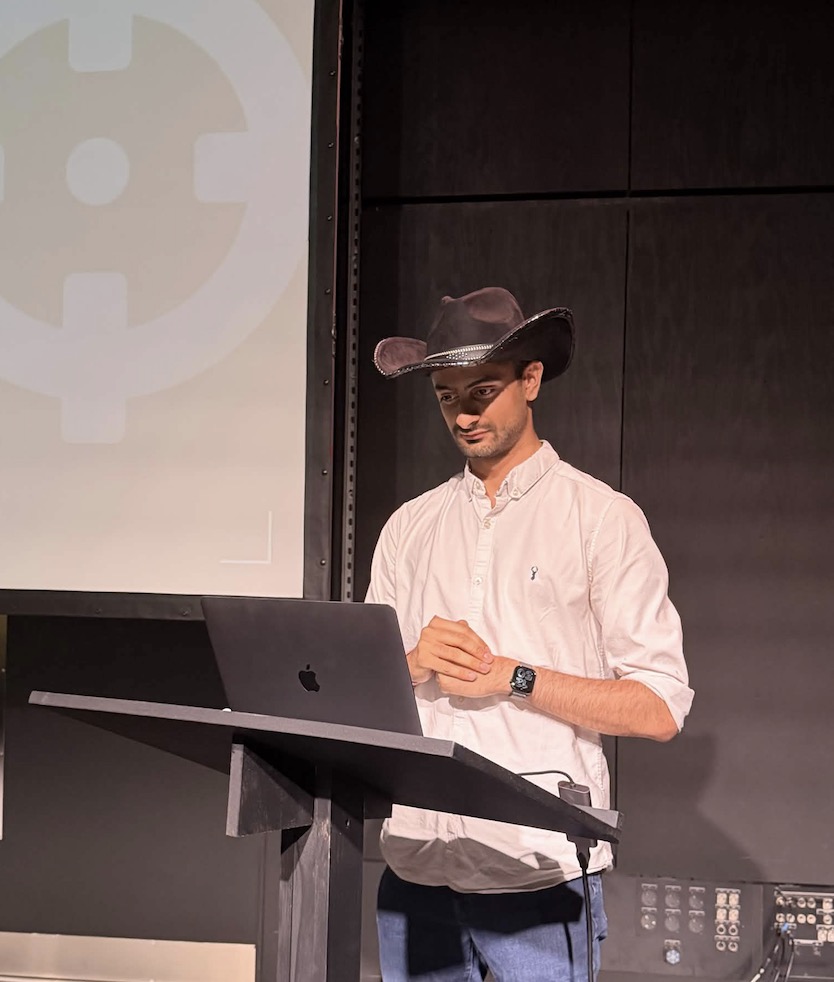 Rishi — @rxerium speaking on stage